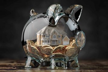 Glass piggy bank with coins and house. Mortgage, savings for real estate or to buy a house concept. 3d illustration