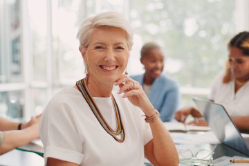 Meeting, smile and face of a business woman, leader or ceo in the office conference room with emplo.