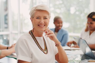 Meeting, smile and face of a business woman, leader or ceo in the office conference room with emplo.